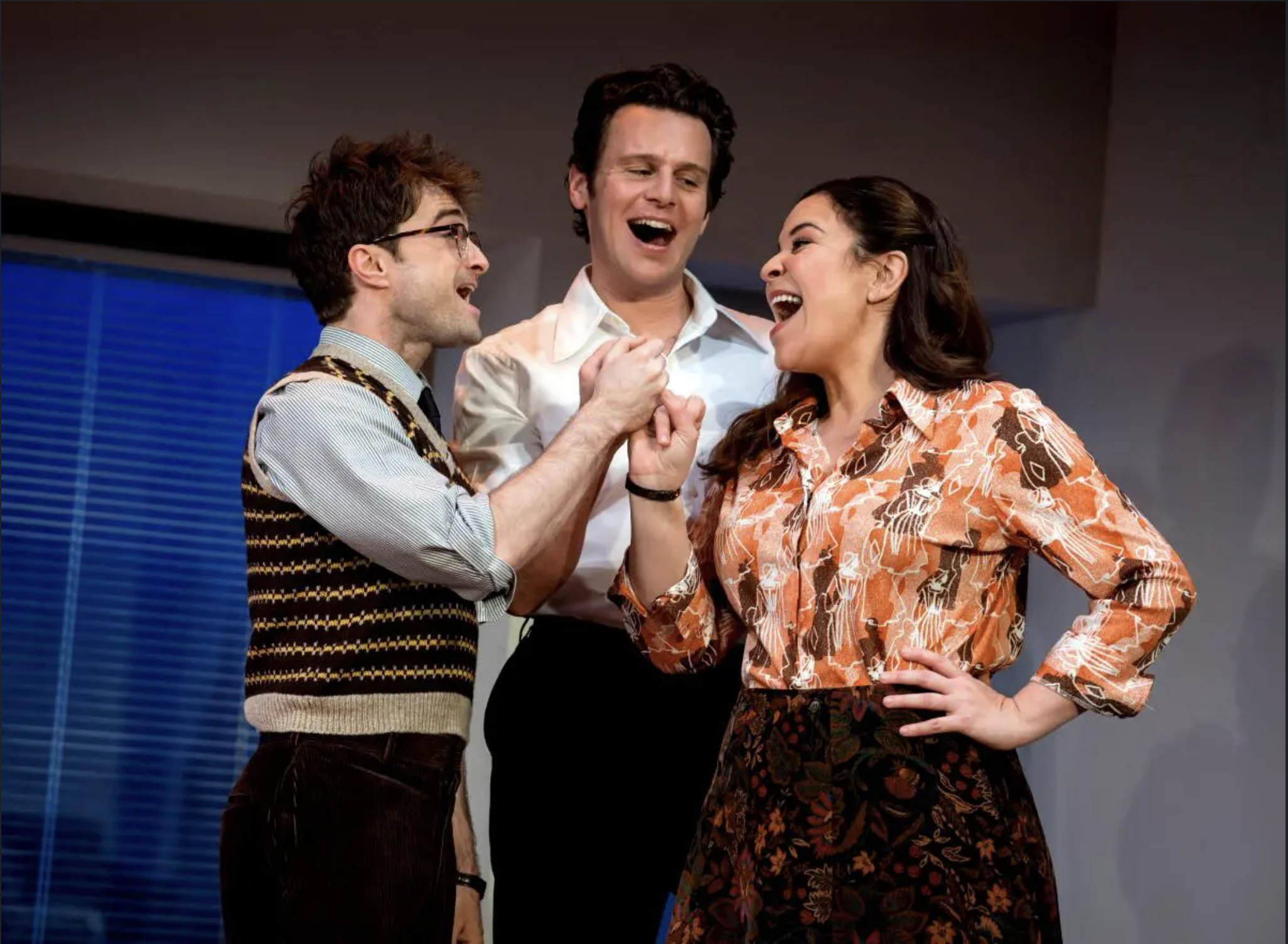 Daniel Radcliffe, Jonathan Groff, and Lindsay Mendez on stage.
