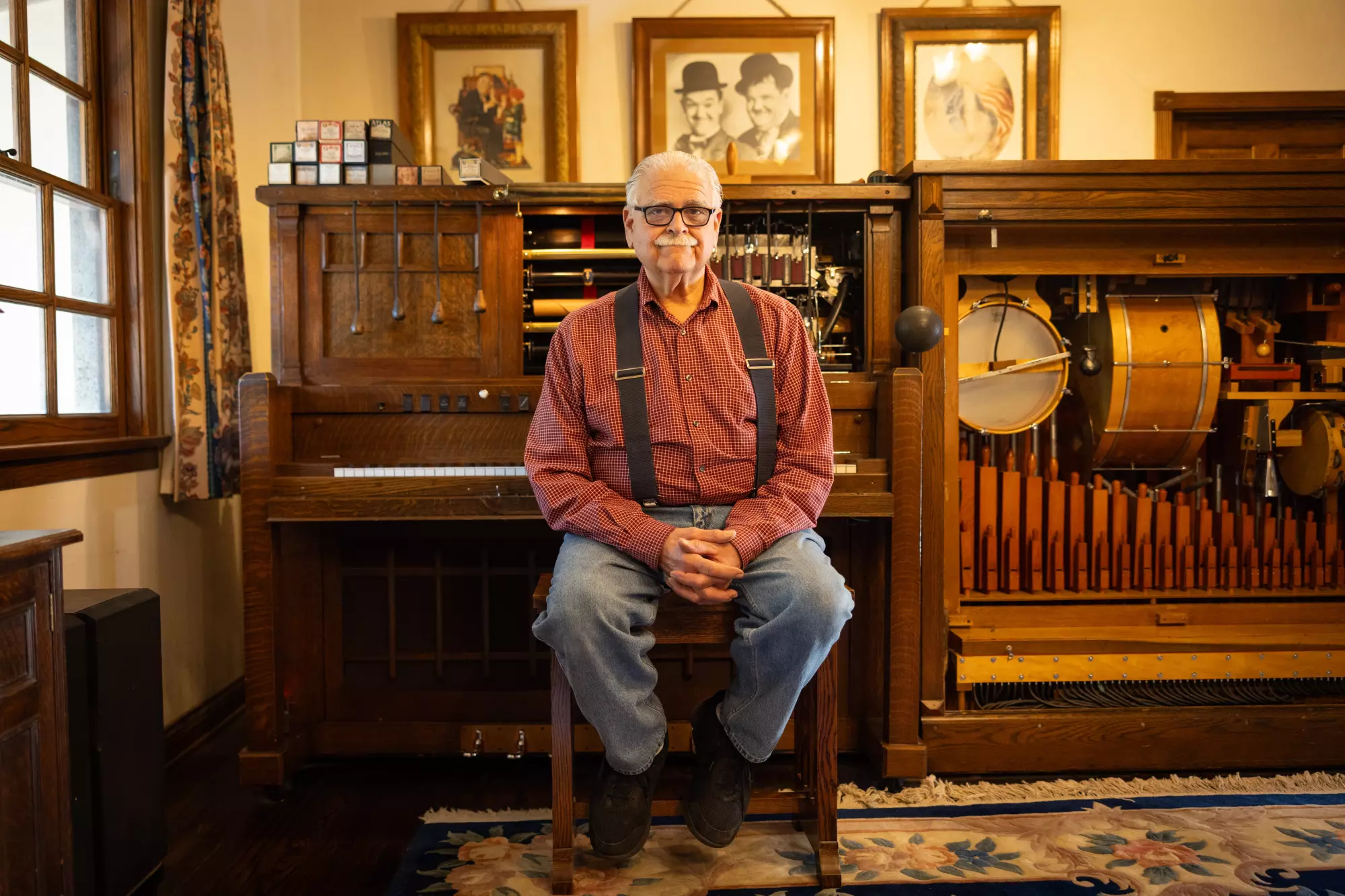 Joe Rinaudo sits at his photoplayer in his house.